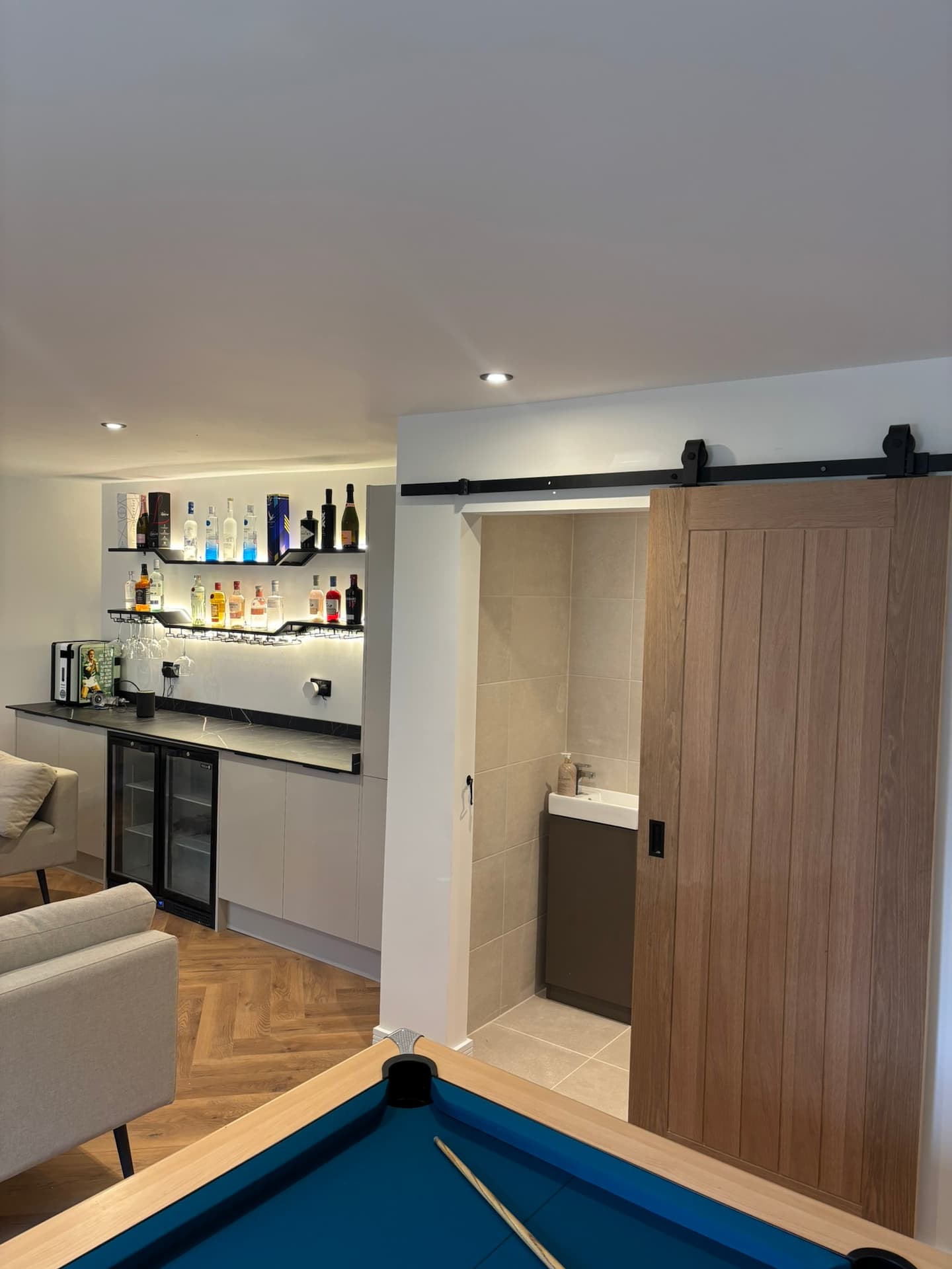 finished-outhouse-bar-area-glasgow.webp Bespoke bar with LED lighting and drinks storage
